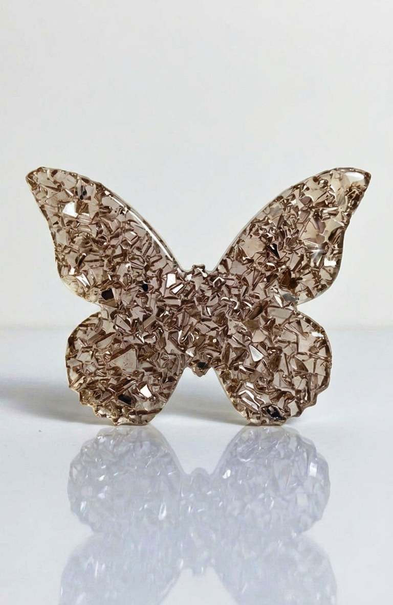 A person holding the flexible butterfly silicone mold to show its thickness, scale
relative to a human hand, and product durability.