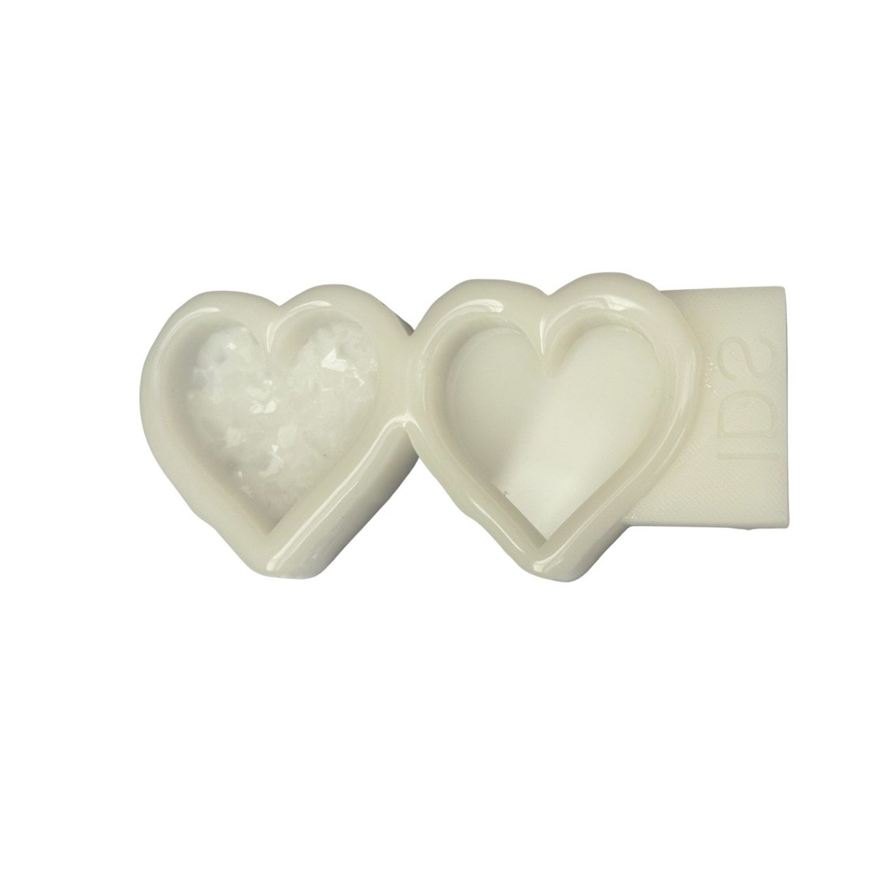 An off-white heart-shaped wax melt or soap mold set, featuring one heart filled with white crystalline salt and the other empty, with a rectangular backing piece showing the embossed brand name 'IDA'.

